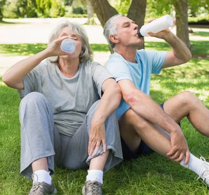 An older couple resting after exercise outdoors, the everyday wellbeing SugarReset is marketed around